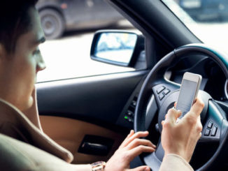 man texting and driving