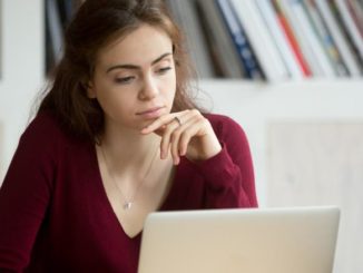 woman looking at insurance coverage options on computer