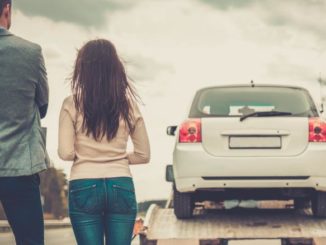 SR22 insurance couple watching car get towed