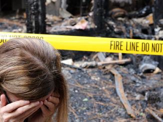 home inventory woman crying in front house fire