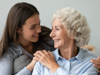 young woman embracing senior woman