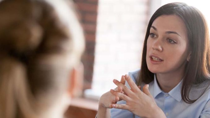 woman-navigating-insurance-adjuster-conversation woman discussing what not to say to an insurance adjuster